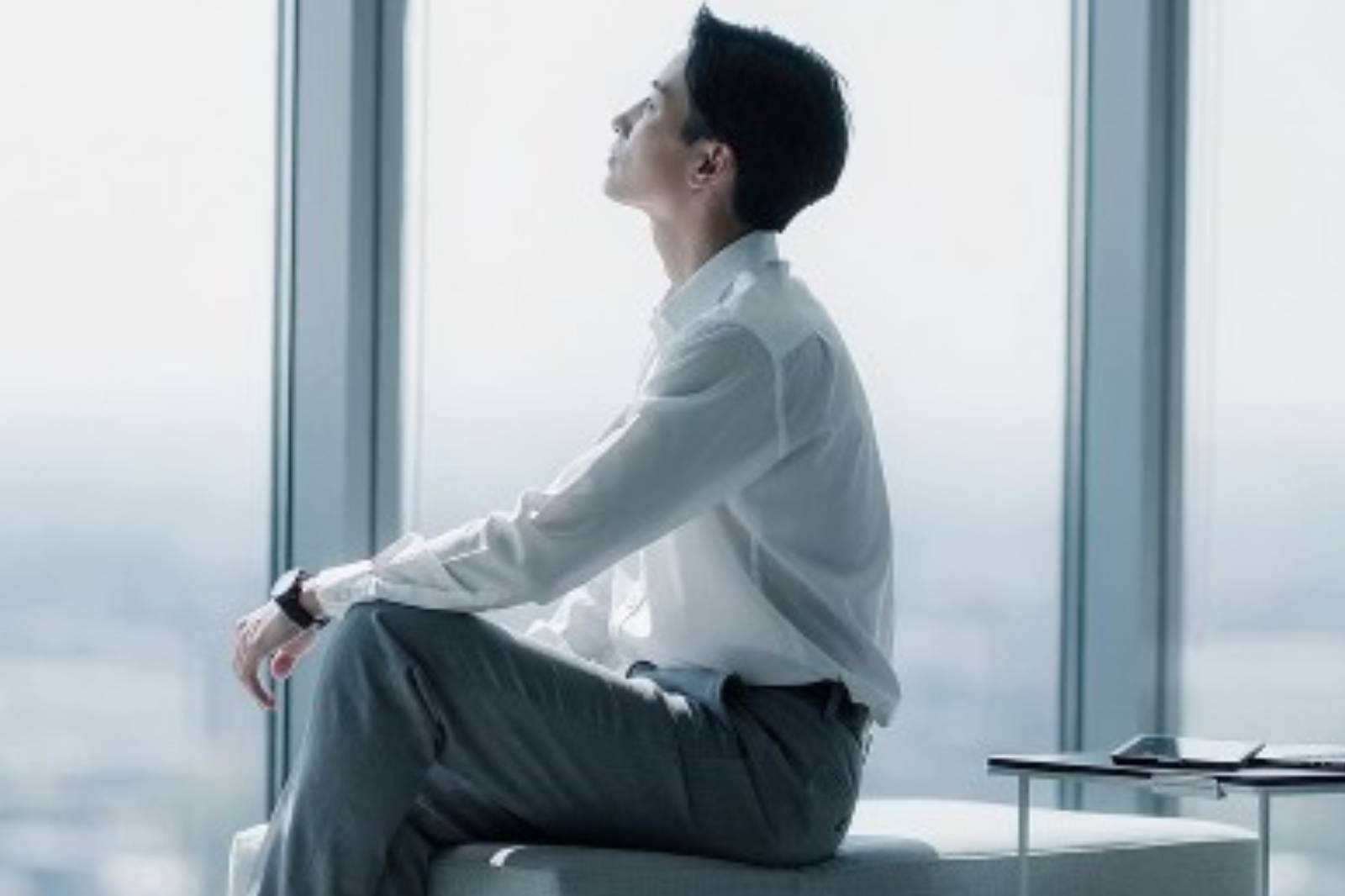 a man and a woman sitting at a table with a laptop