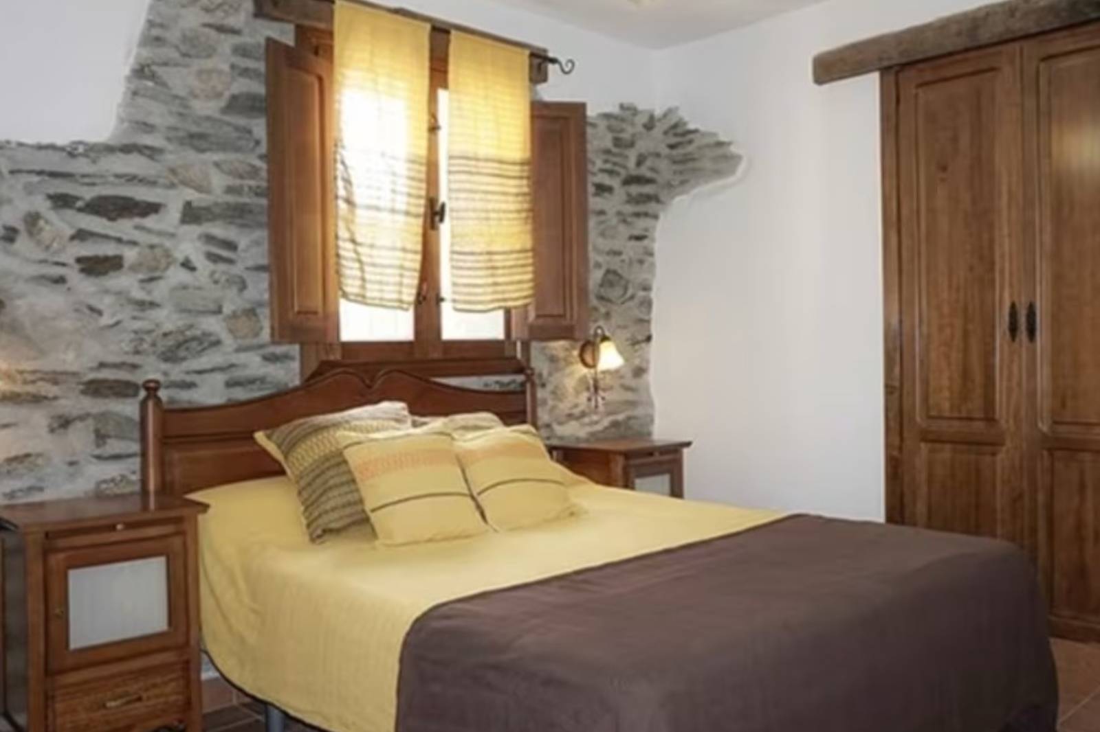 man in black suit jacket holding black smartphone